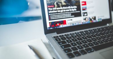 gray laptop computer near journals
