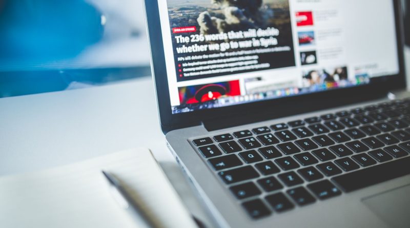 gray laptop computer near journals